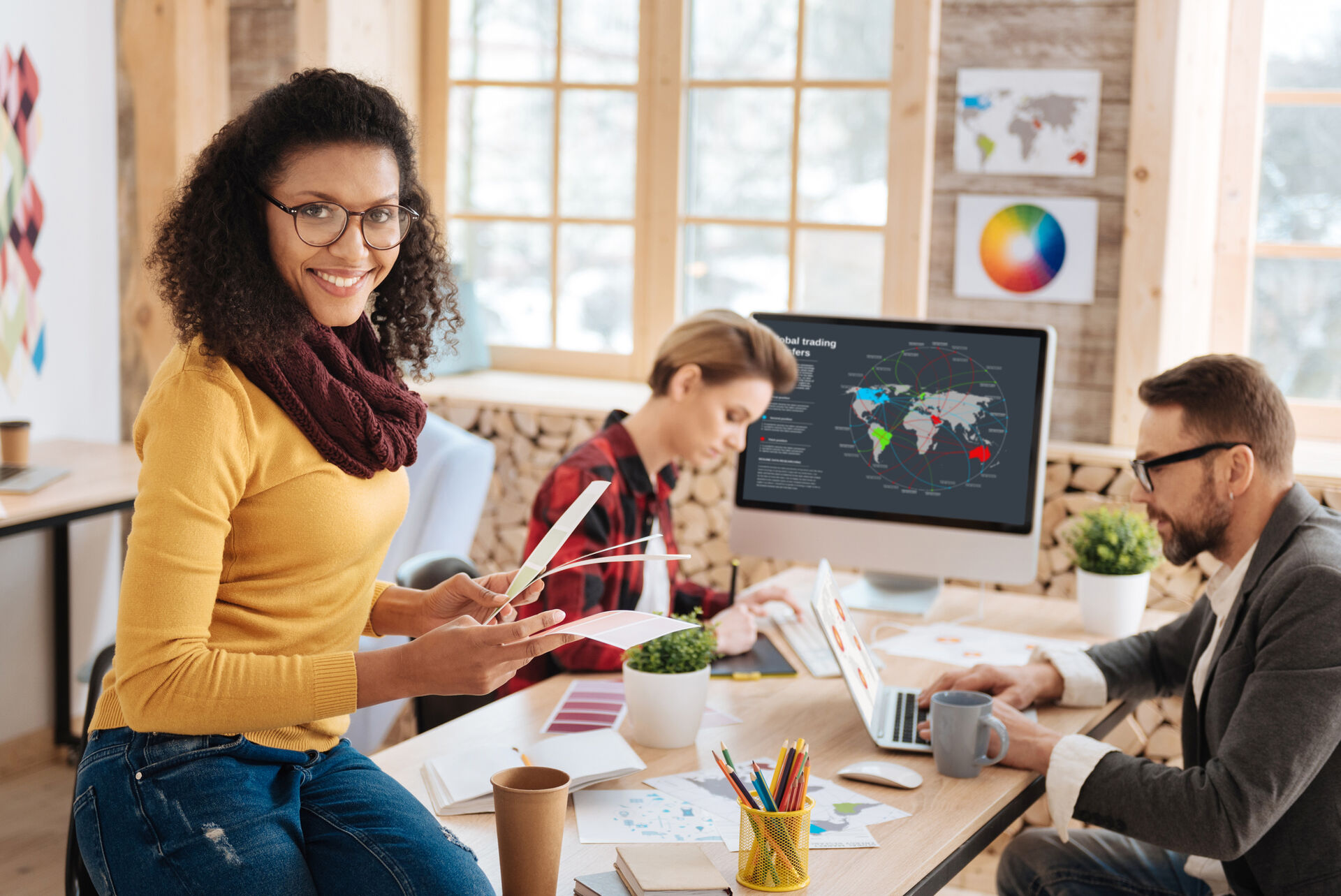 A young startup team is working in an office on computers.