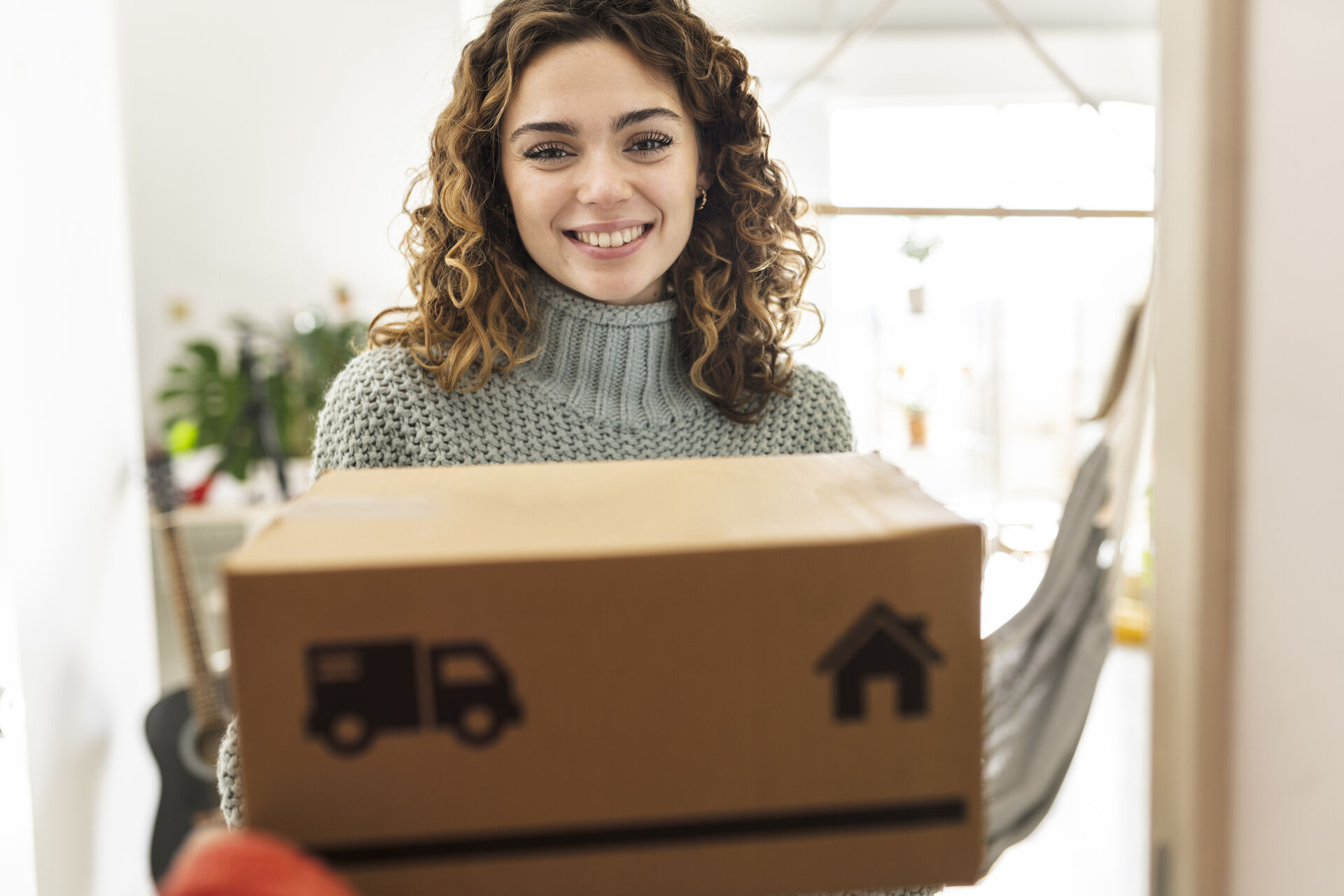 A Spanish woman receives a package delivery.