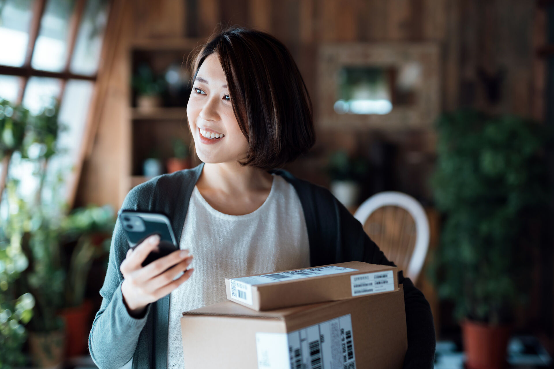 A woman with packages ready for shipping in a startup.